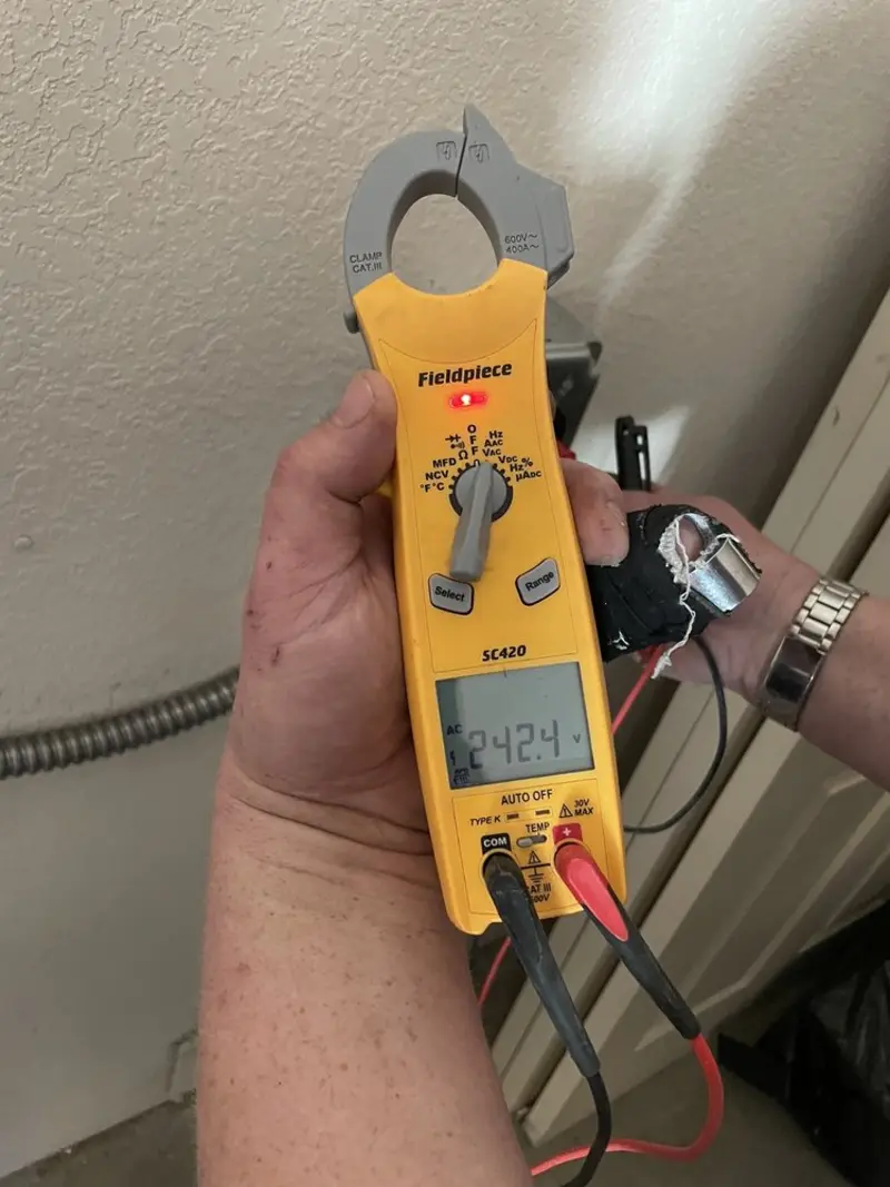 Voltage testing with clamp meter during Electrical Installation Services in Dyersville